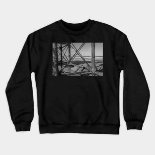 Jetty metal work on a sandy beach Crewneck Sweatshirt